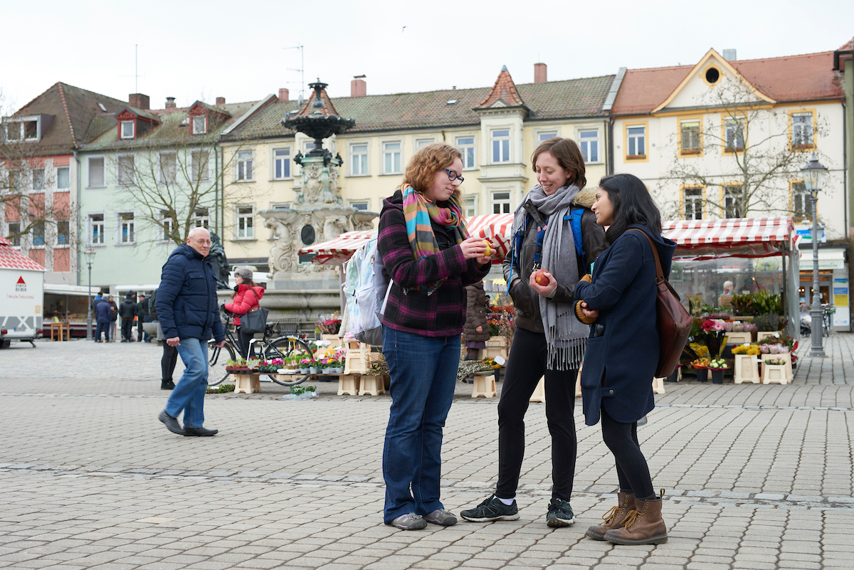 Three women in a town square in Germany